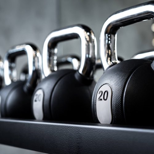 close-up-of-new-dumbbells-on-a-rack-in-a-gym-T2TRKFG